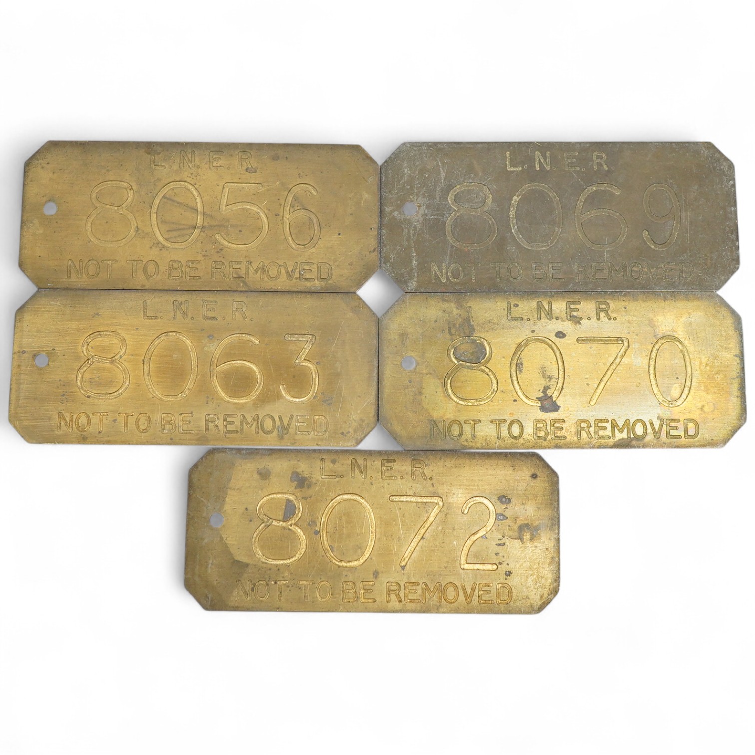 Five brass LNER engraved railway locomotive plates; ‘Not To Be Removed’, locomotive numbers; 8056, 8063, 8069, 8070, and 8072, each 11.8 x 5cm